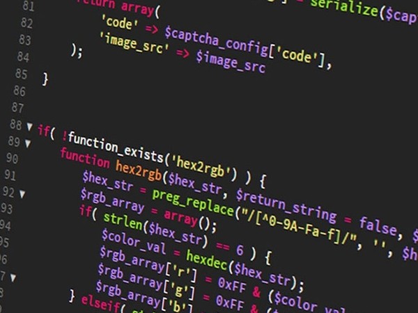 Close-up of a computer screen showing colorful lines of PHP code defining a function named hex2rgb with syntax highlighting.